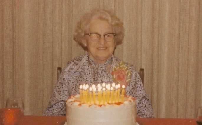 Raye Green in front of birthday cake